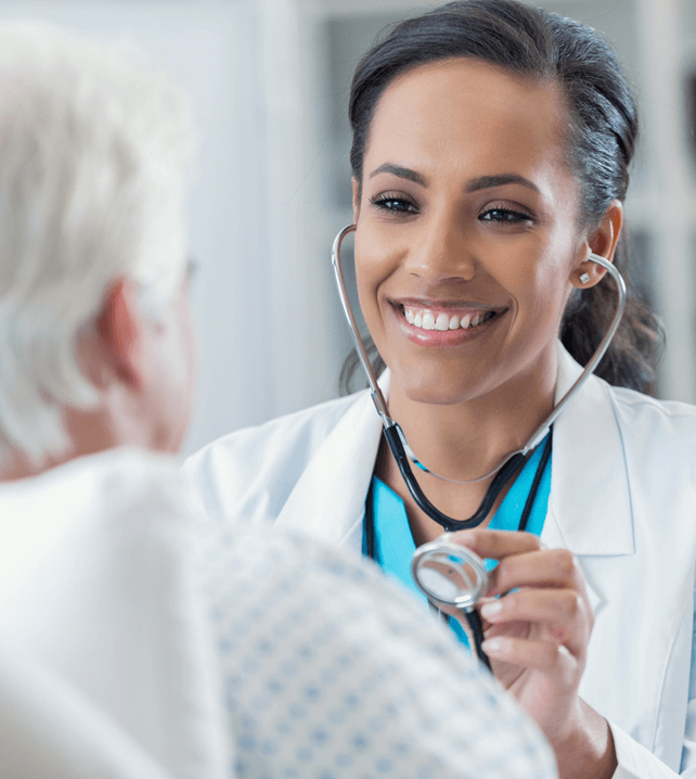 female primary care doctor examing patient with a stethoscope 
