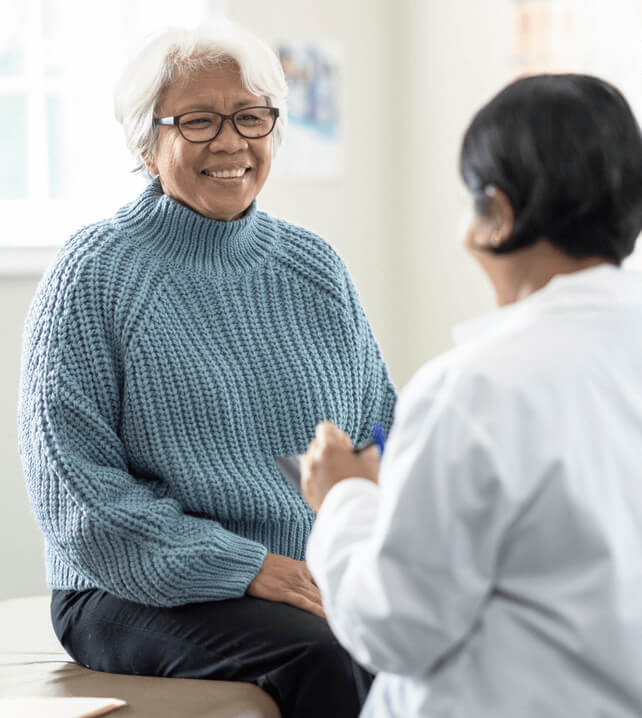 doctor talking to elderly patient