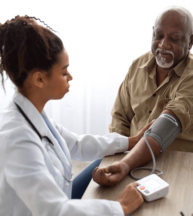 primary care doctor measuring patient's blood pressure