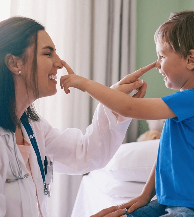 pediatric doctor and her patient touching each others noses