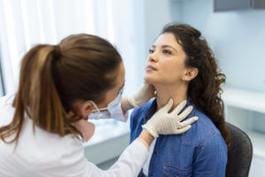 doctor examining step throat condtion of a female patient