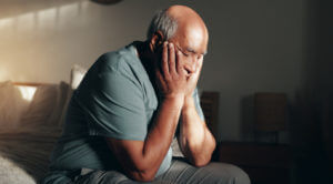 A senior man at home is going through anxiety and depression.