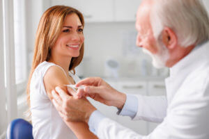 Doctor giving vaccine to patient.